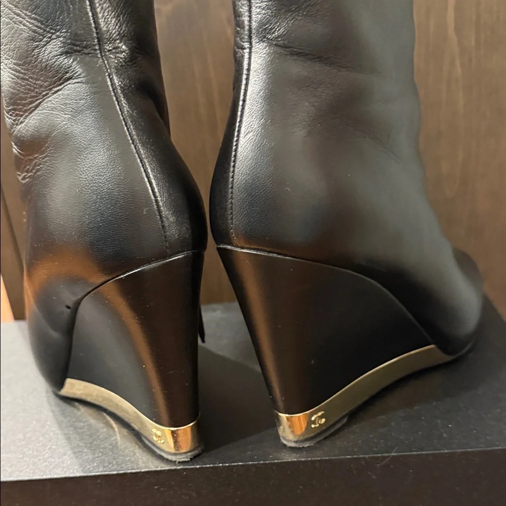 CHANEL Black Leather Wedge Boots with Gold Accent